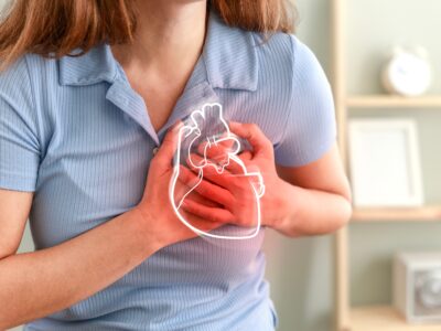 Close-up of woman clutching chest with animated picture of heart while suffering heart attack symptoms