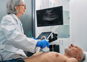 A doctor scans a patient's heart for a carotid ultrasound