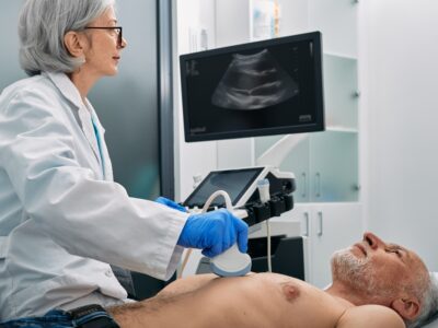 A doctor scans a patient's heart for a carotid ultrasound